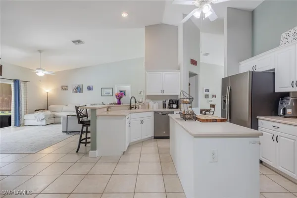 a kitchen with a sink cabinets and window