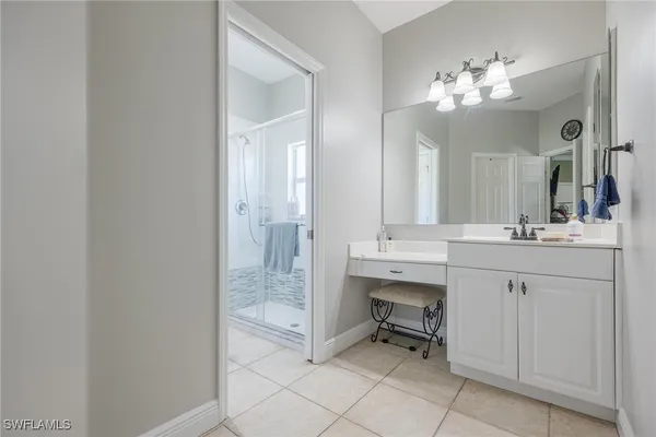 a bathroom with a double vanity sink mirror and cabinets