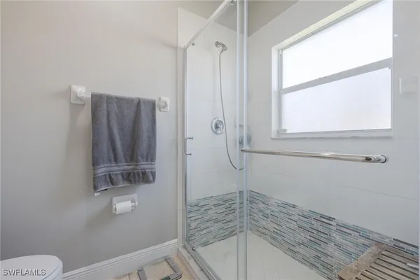 a bathroom with a shower toilet and sink