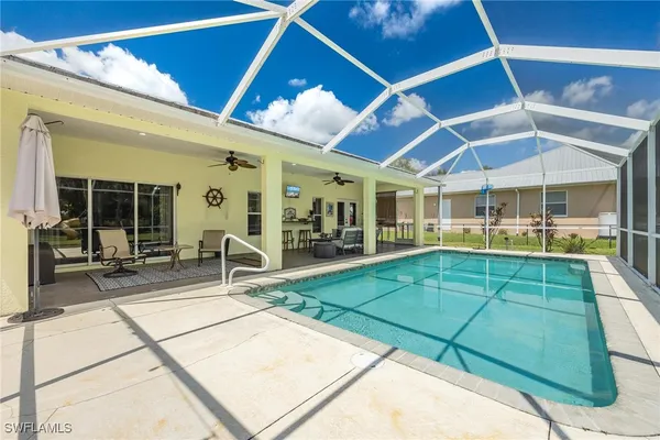 a view of a patio with a table and chairs under an umbrella