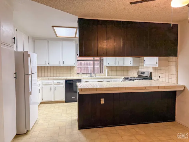 a kitchen with stainless steel appliances a sink stove and refrigerator