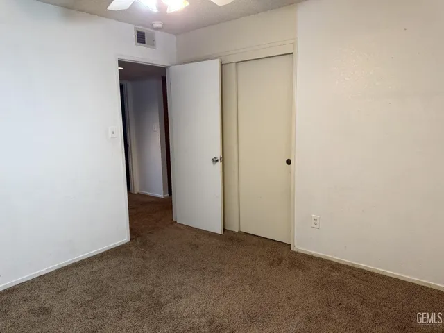 an empty room with closet area