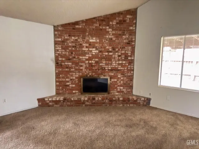 a view of an empty room with a fireplace