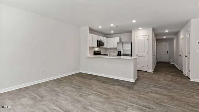 a view of kitchen with wooden floor and window