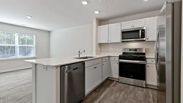 a kitchen with a sink stove and microwave