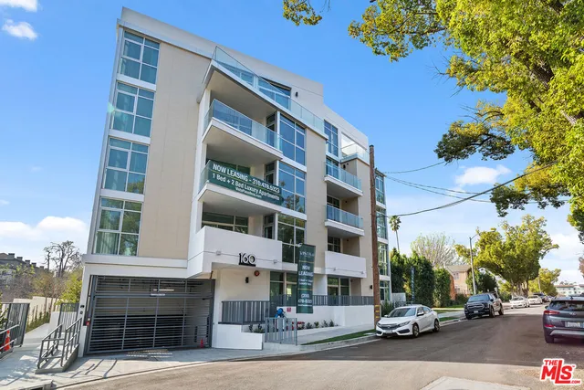 a view of a cars park in front of a building