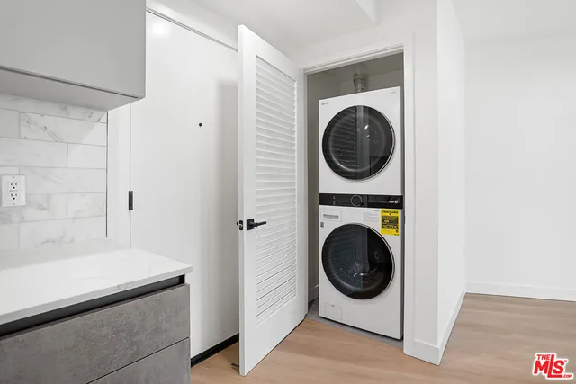 a utility room with sink dryer and washer