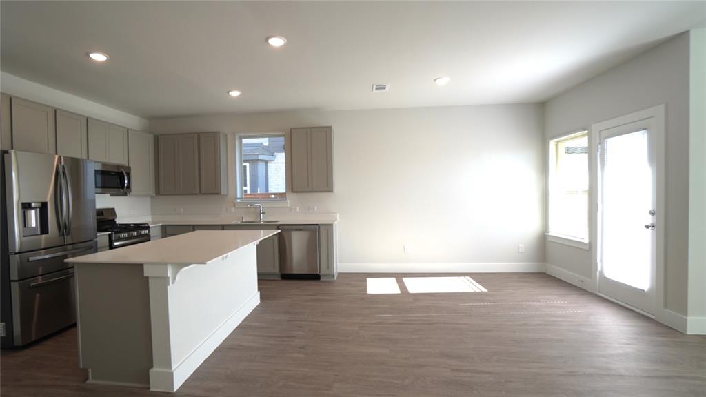 1374 Chisos Way Forney, TX 75126 - Photo 12 of 25 a kitchen with granite countertop a sink stove and refrigerator
