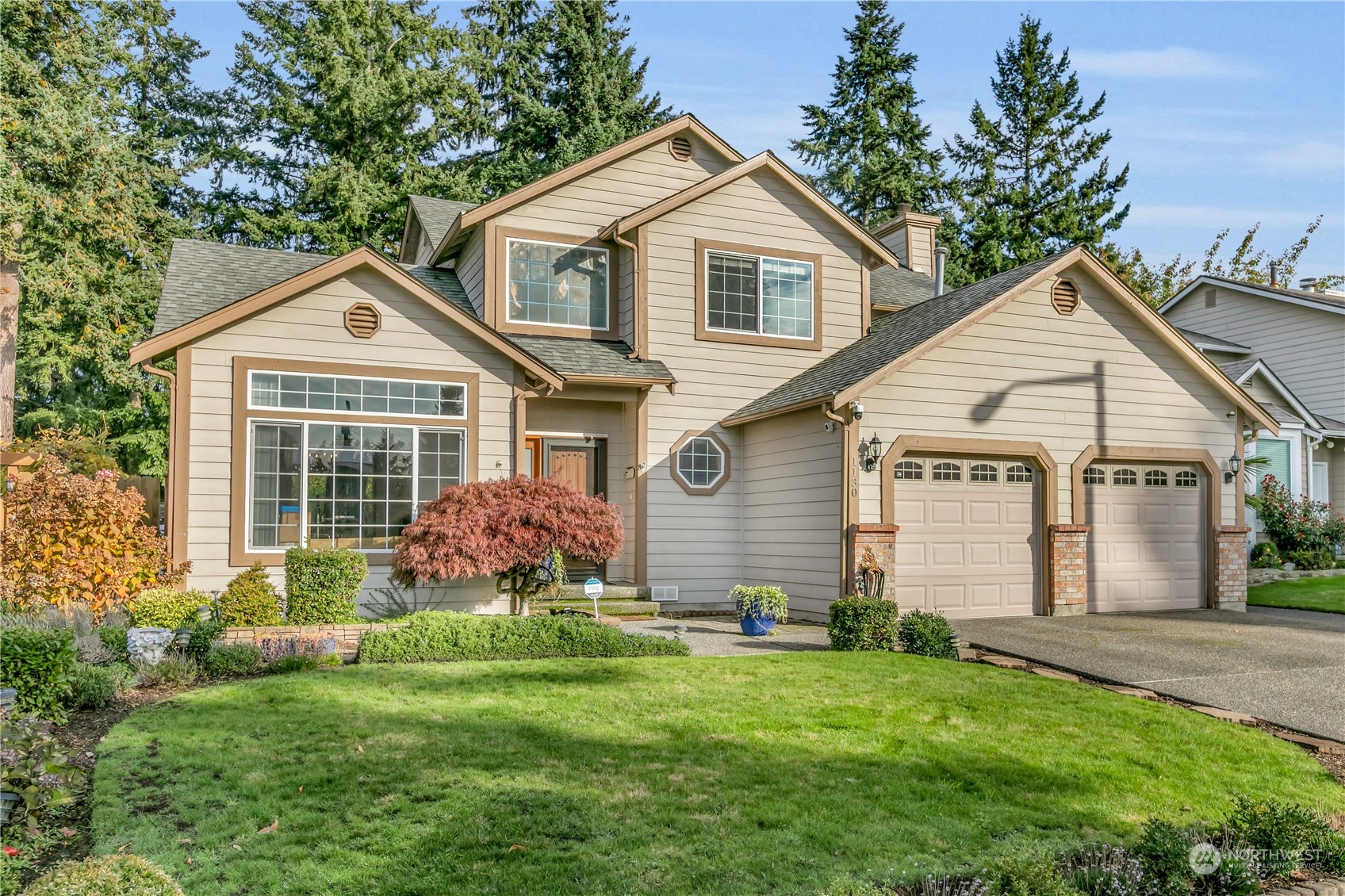 1130 Southwest 354th Street Federal Way, WA 98023 - Photo 1 of 25 a front view of a house with a yard and garage