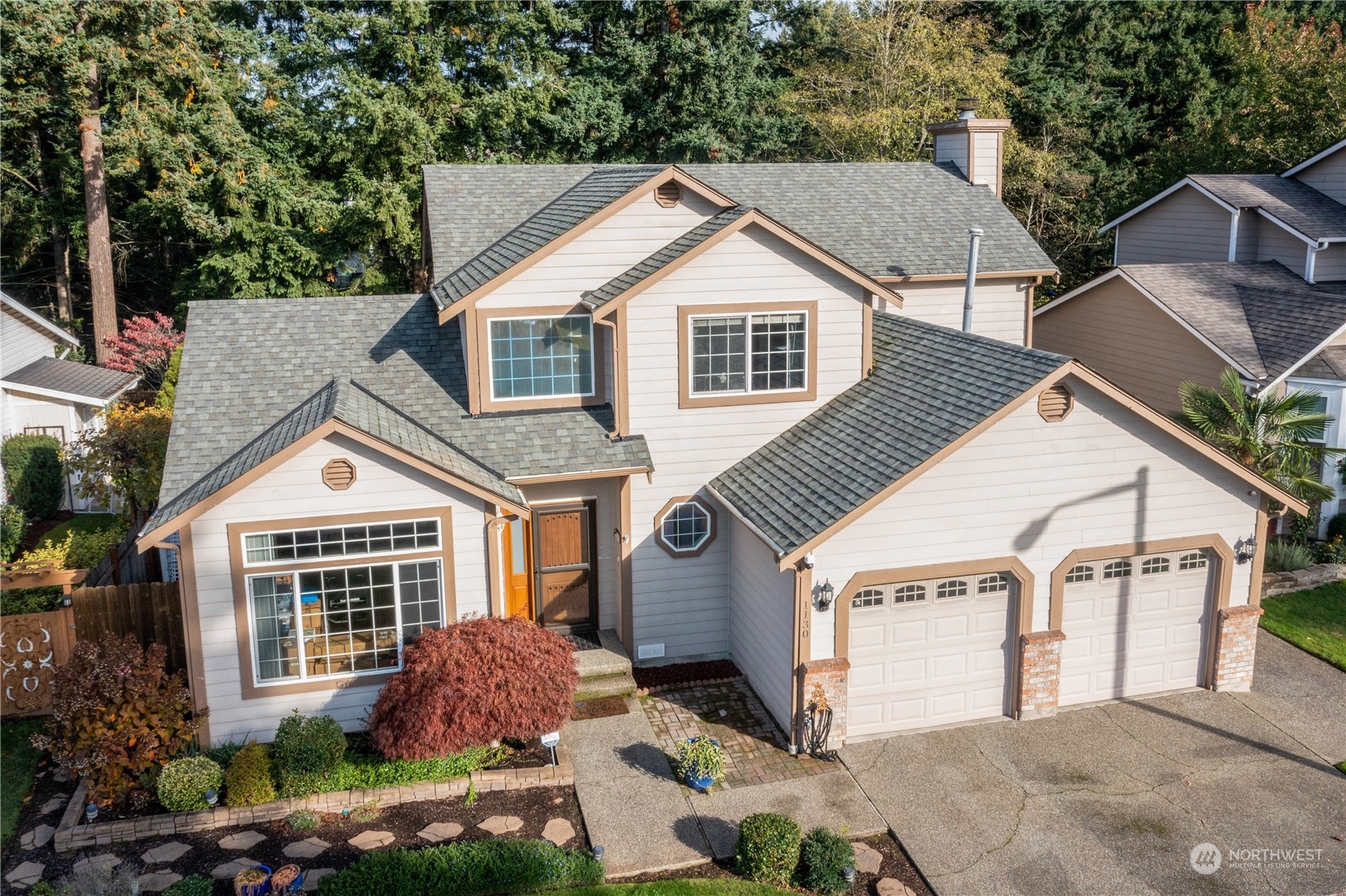 1130 Southwest 354th Street Federal Way, WA 98023 - Photo 2 of 25 a front view of a house with a yard and garage