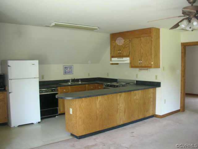 3390 Forest Grove Road Sandy Hook, VA 23153 - Photo 2 of 10 a kitchen with stainless steel appliances granite countertop a refrigerator and a stove