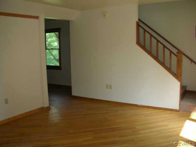 3390 Forest Grove Road Sandy Hook, VA 23153 - Photo 4 of 10 a view of an empty room with wooden floor and a window