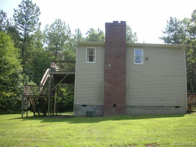 3390 Forest Grove Road Sandy Hook, VA 23153 - Photo 9 of 10 a view of a backyard with a cabin