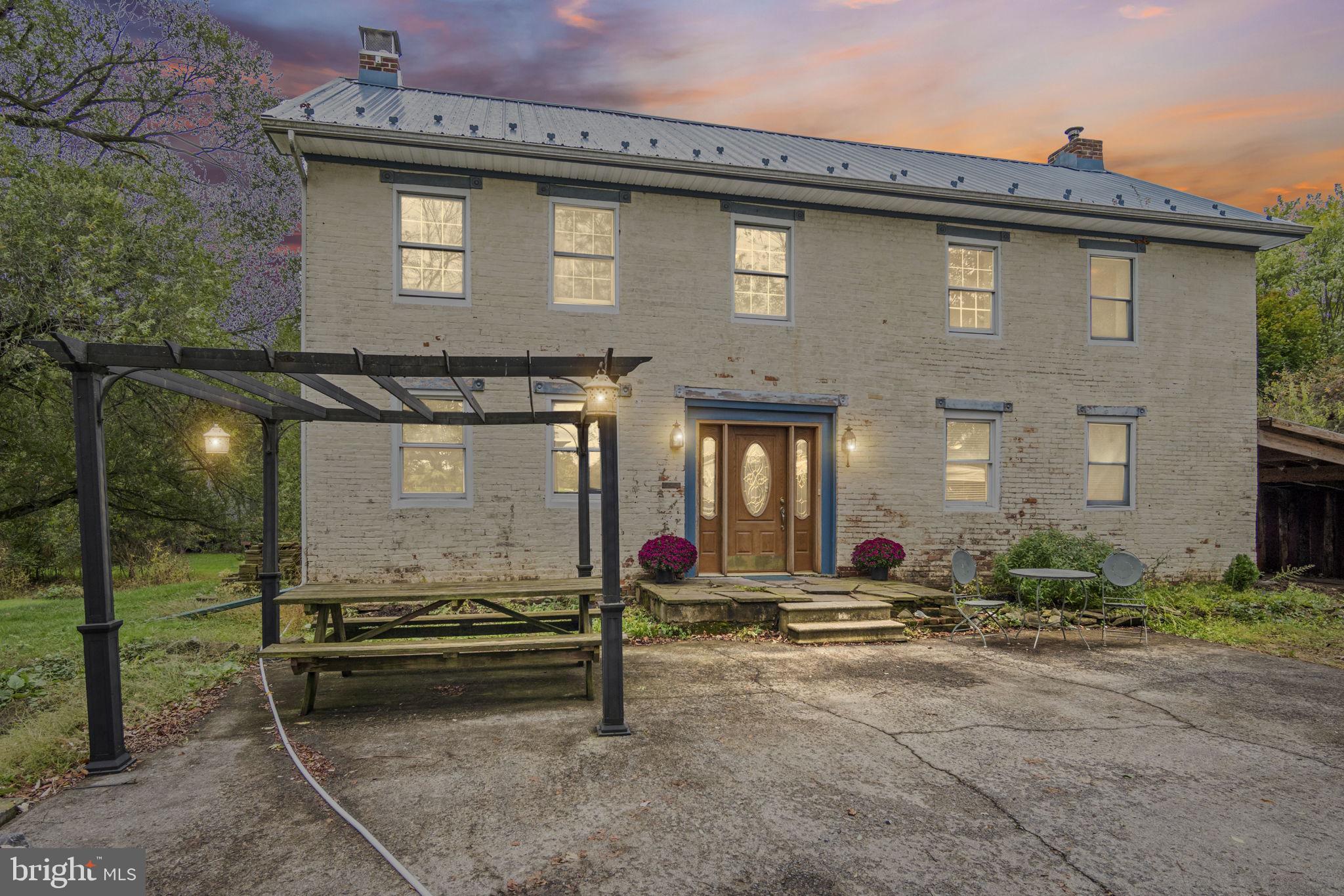 a backyard of a house with barbeque oven table and chairs