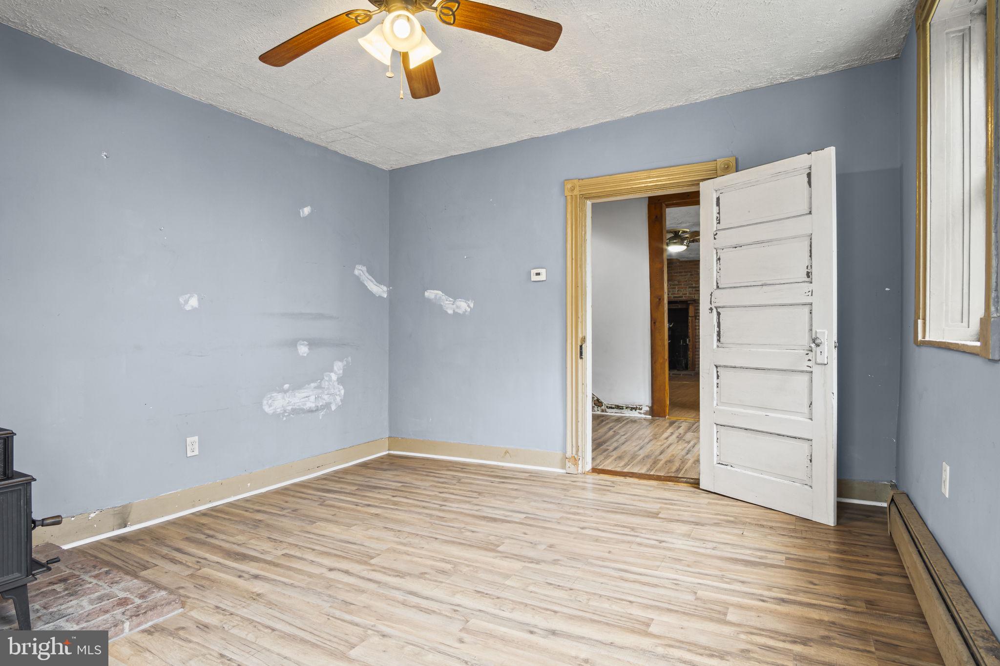 2065 Goldenville Road Gettysburg, PA 17325 - Photo 12 of 51 an empty room with wooden floor cabinet and windows