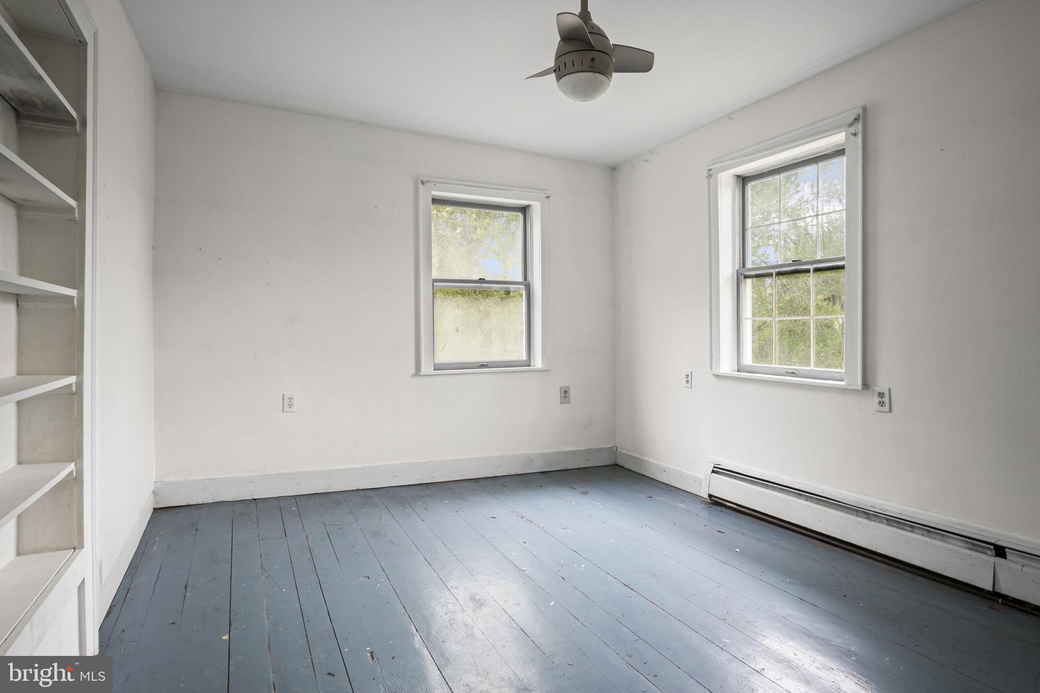 2065 Goldenville Road Gettysburg, PA 17325 - Photo 20 of 51 an empty room with wooden floor chandelier fan and windows