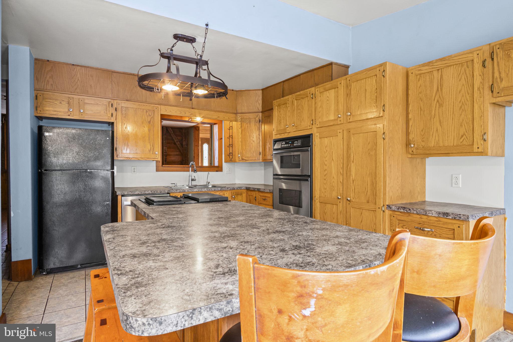 2065 Goldenville Road Gettysburg, PA 17325 - Photo 4 of 51 a kitchen with stainless steel appliances granite countertop a sink refrigerator and cabinets