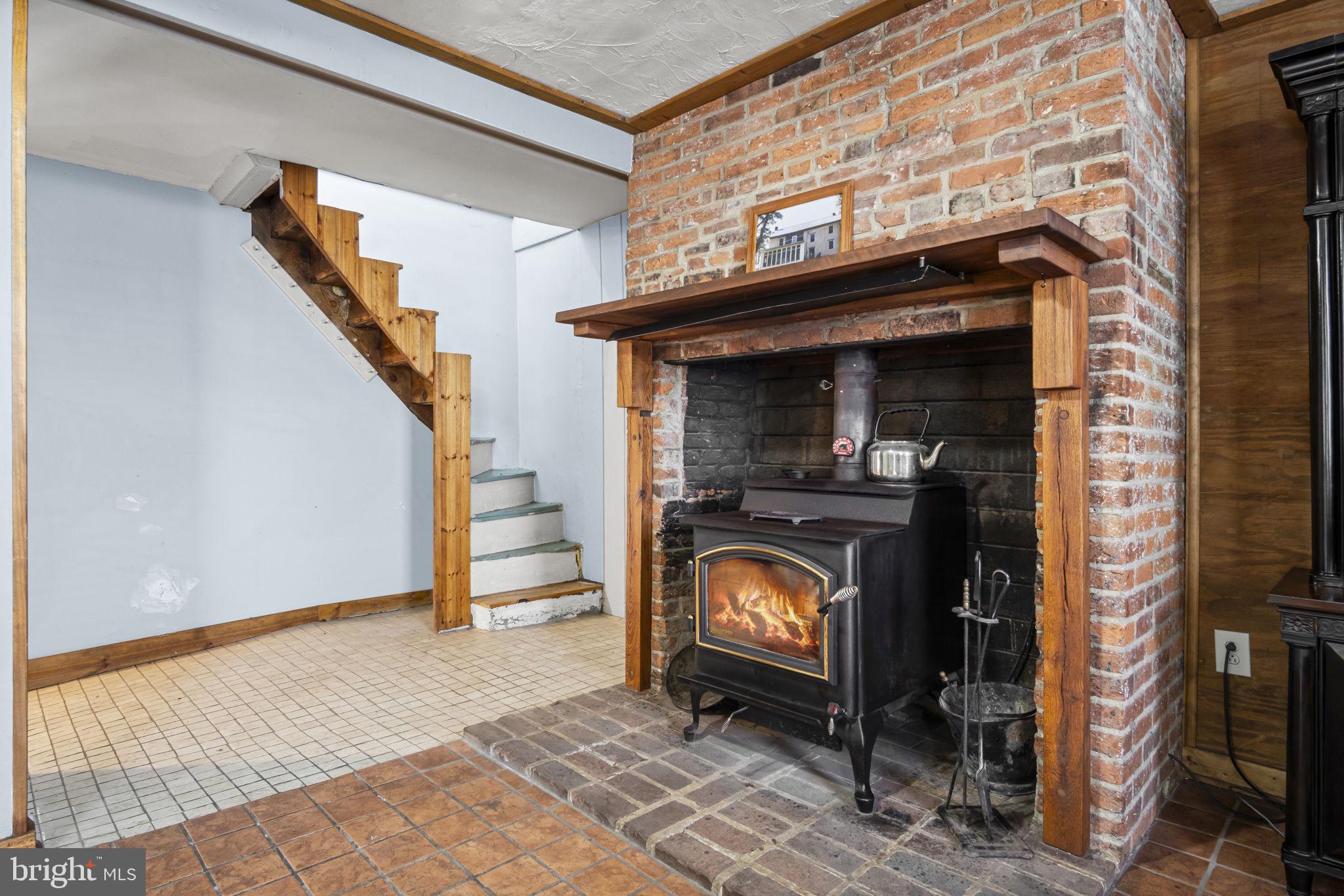 2065 Goldenville Road Gettysburg, PA 17325 - Photo 8 of 51 a view of an empty room with wooden floor and a fireplace