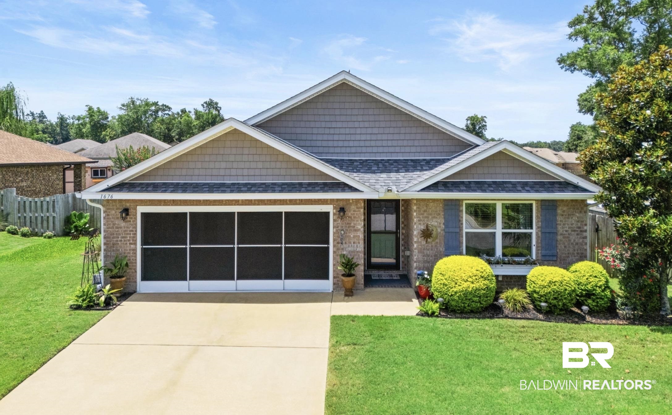 1676 Abbey Loop Foley, AL 36535 - Photo 1 of 31 Brick facade home featuring a two-car garage with a screen door system