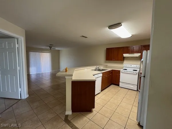 a kitchen with a sink a stove top oven and cabinets