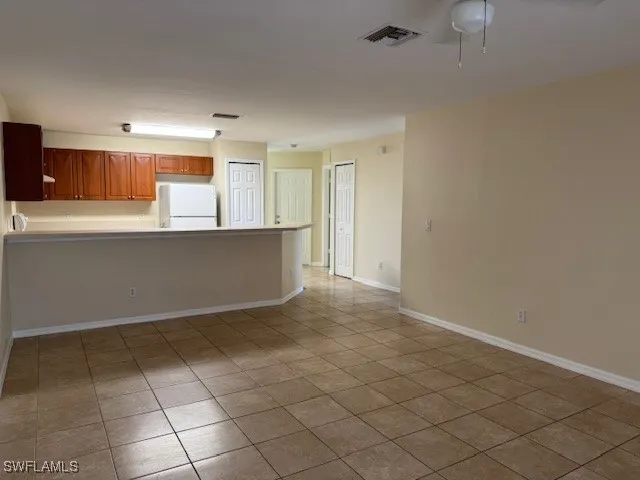 a view of kitchen with granite countertop cabinets
