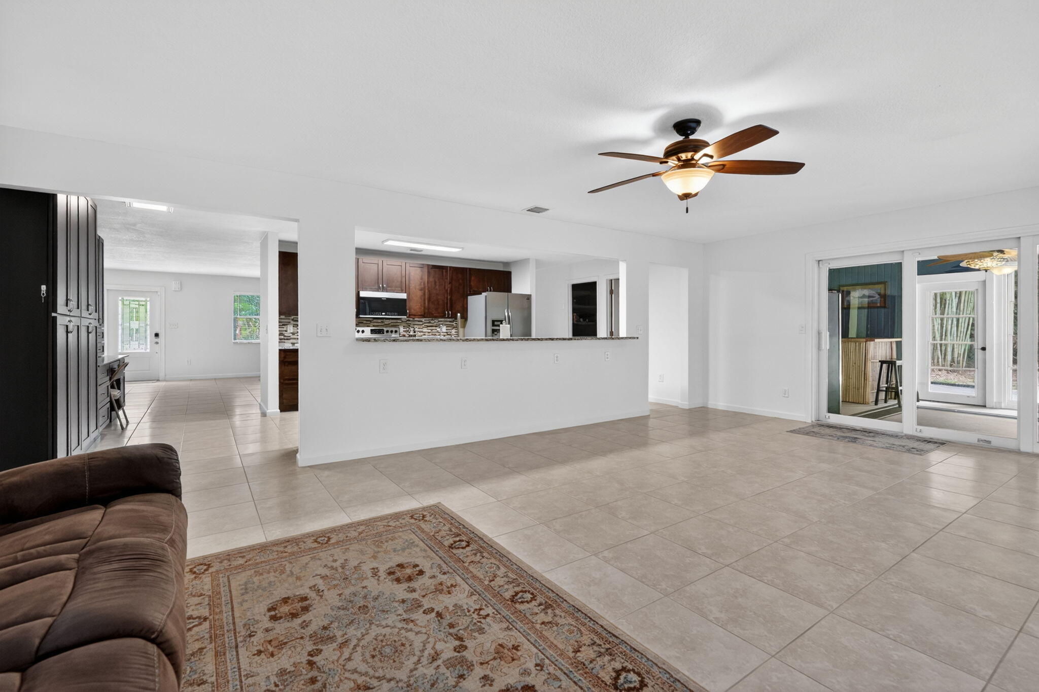 17391 Alexander Run Jupiter, FL 33478 - Photo 26 of 55 a living room with furniture and kitchen view