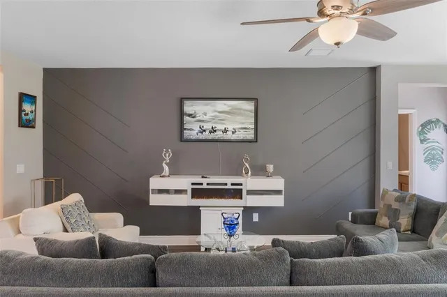 a living room with furniture and a chandelier