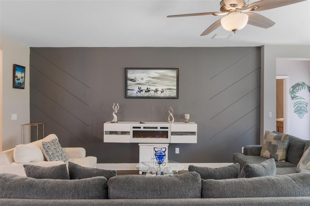 1108 Cavender Creek Road Minneola, FL 34715 - Photo 12 of 54 a living room with furniture and a window