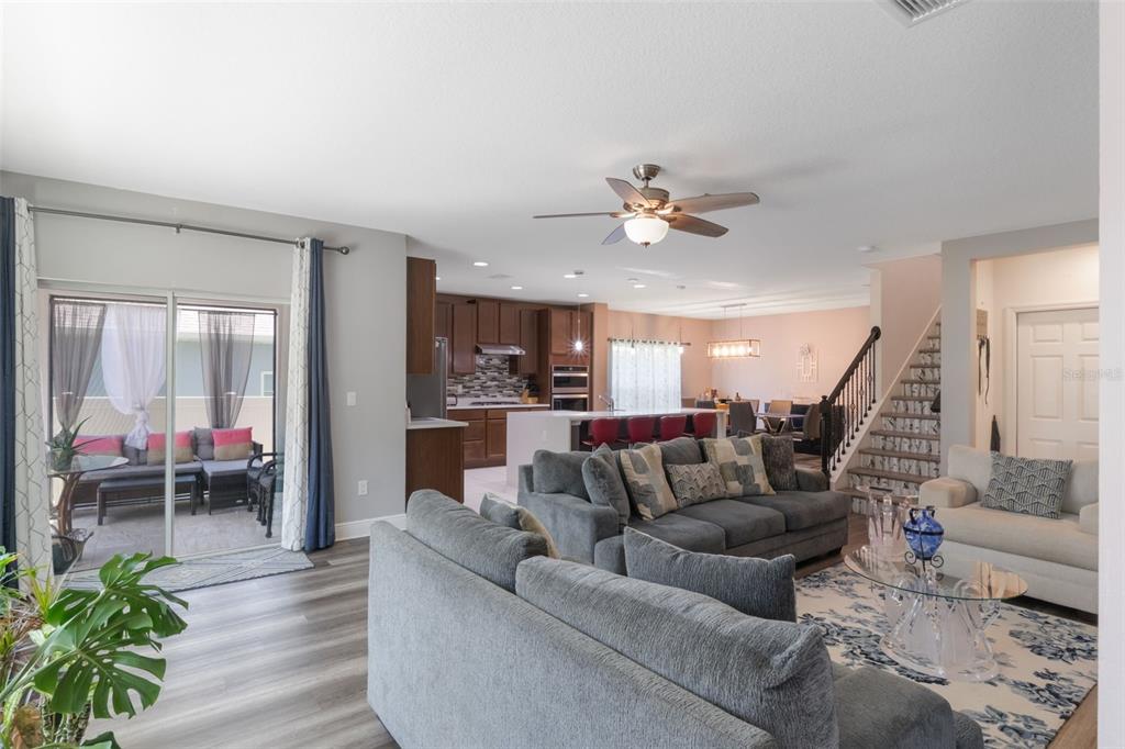 1108 Cavender Creek Road Minneola, FL 34715 - Photo 13 of 54 a living room with furniture and a chandelier