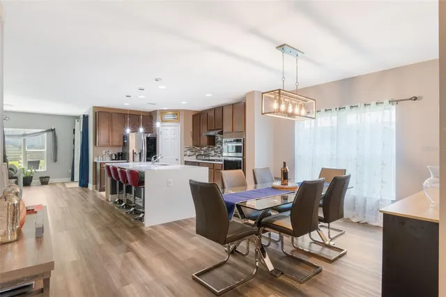 a view of a dining room with furniture window and wooden floor