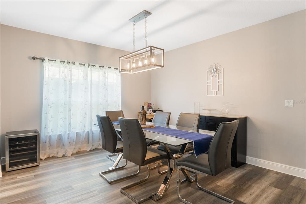 1108 Cavender Creek Road Minneola, FL 34715 - Photo 15 of 54 a view of a dining room with furniture window and wooden floor