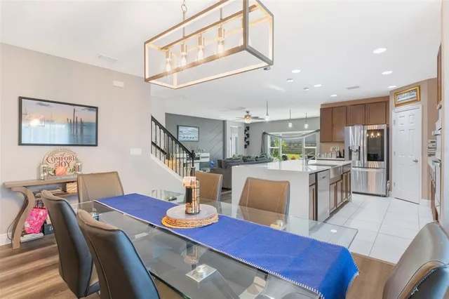 a large living room with stainless steel appliances granite countertop furniture and a kitchen view