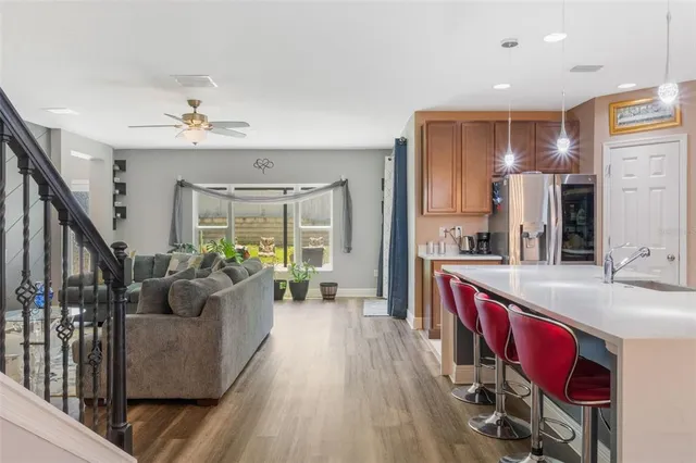 a kitchen with stainless steel appliances kitchen island granite countertop a refrigerator and a stove