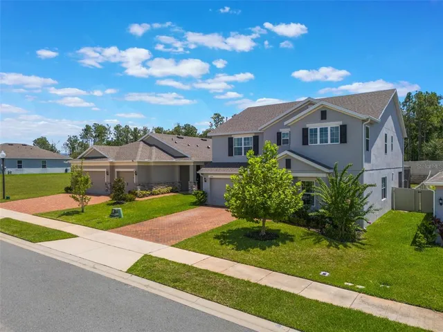 a front view of house with yard and green space