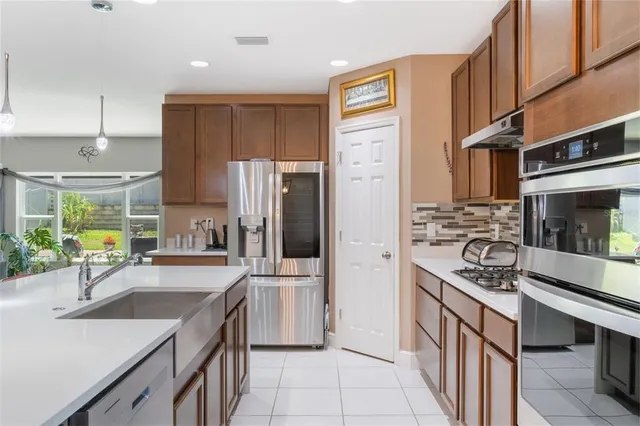 a kitchen with stainless steel appliances granite countertop a stove and a refrigerator