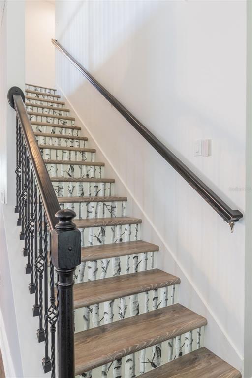 1108 Cavender Creek Road Minneola, FL 34715 - Photo 23 of 54 a view of staircase with railing and white walls