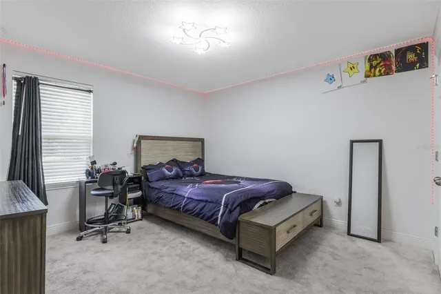 a bedroom with a bed and window