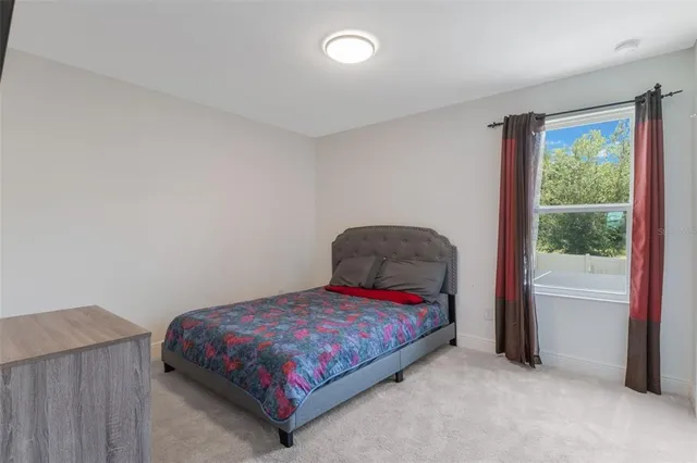 a bed sitting in a room next to a window