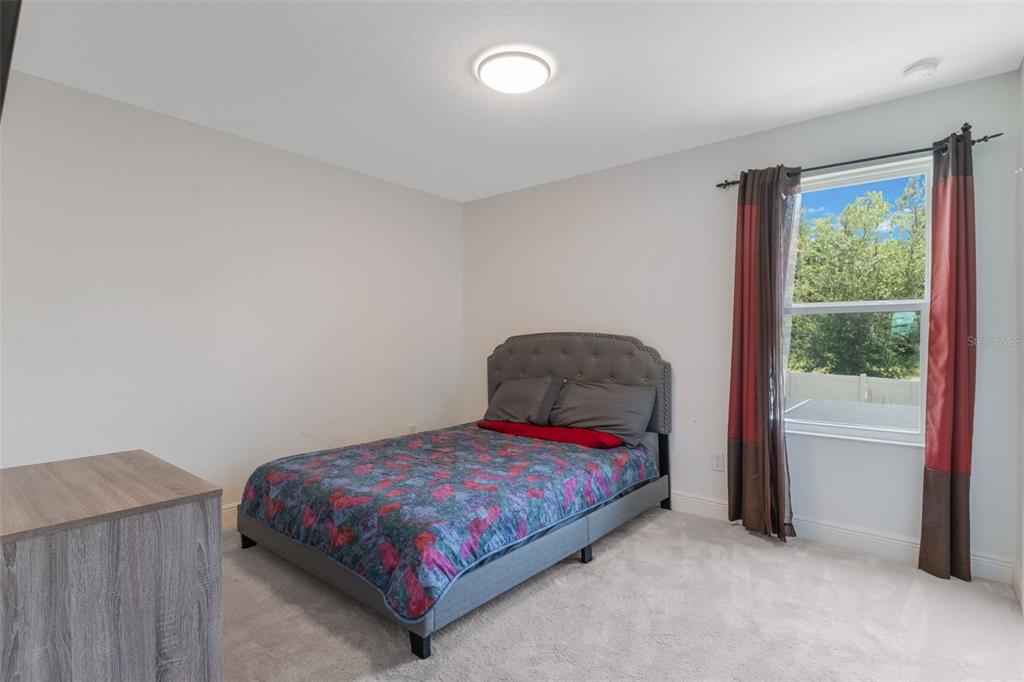 1108 Cavender Creek Road Minneola, FL 34715 - Photo 28 of 54 a bedroom with a bed and window