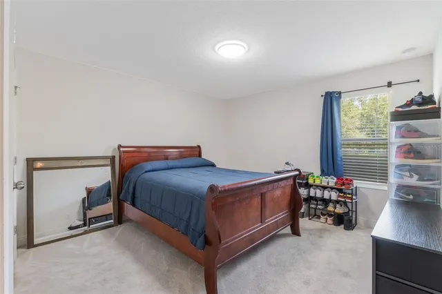 a bedroom with a large bed and a large window