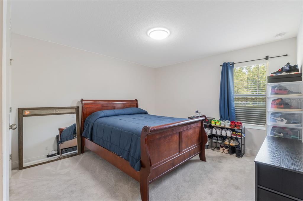 1108 Cavender Creek Road Minneola, FL 34715 - Photo 29 of 54 a bed sitting in a room next to a window