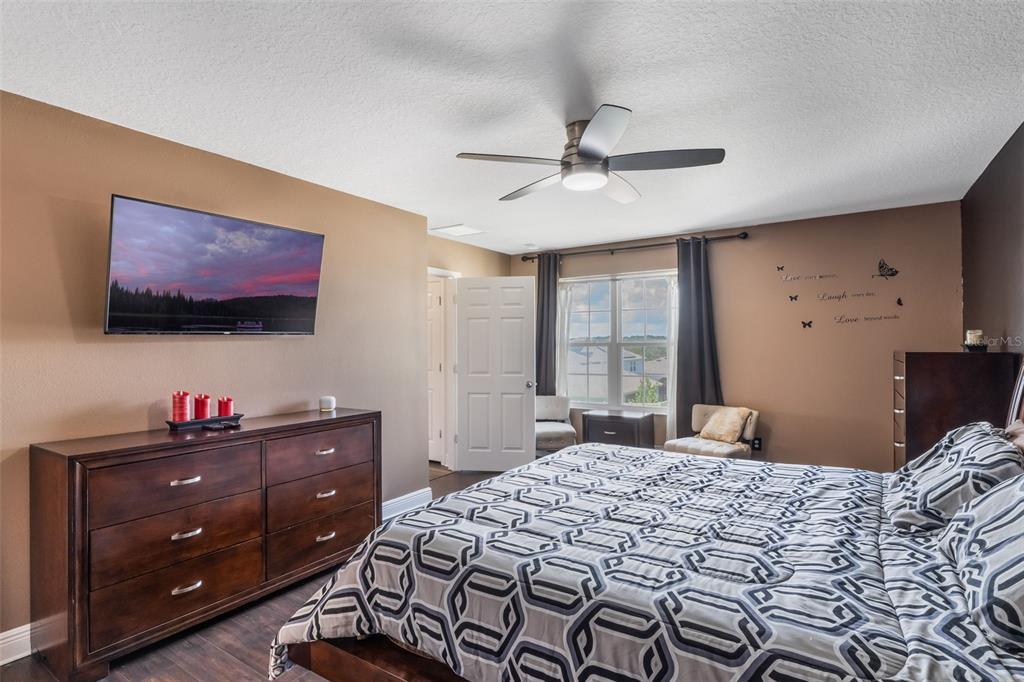 1108 Cavender Creek Road Minneola, FL 34715 - Photo 31 of 54 a bedroom with a bed and a flat screen tv