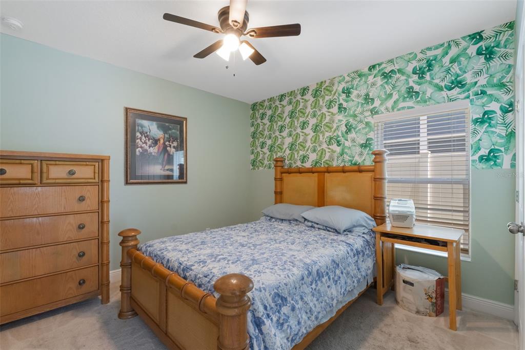 1108 Cavender Creek Road Minneola, FL 34715 - Photo 33 of 54 a bedroom with a bed and a window