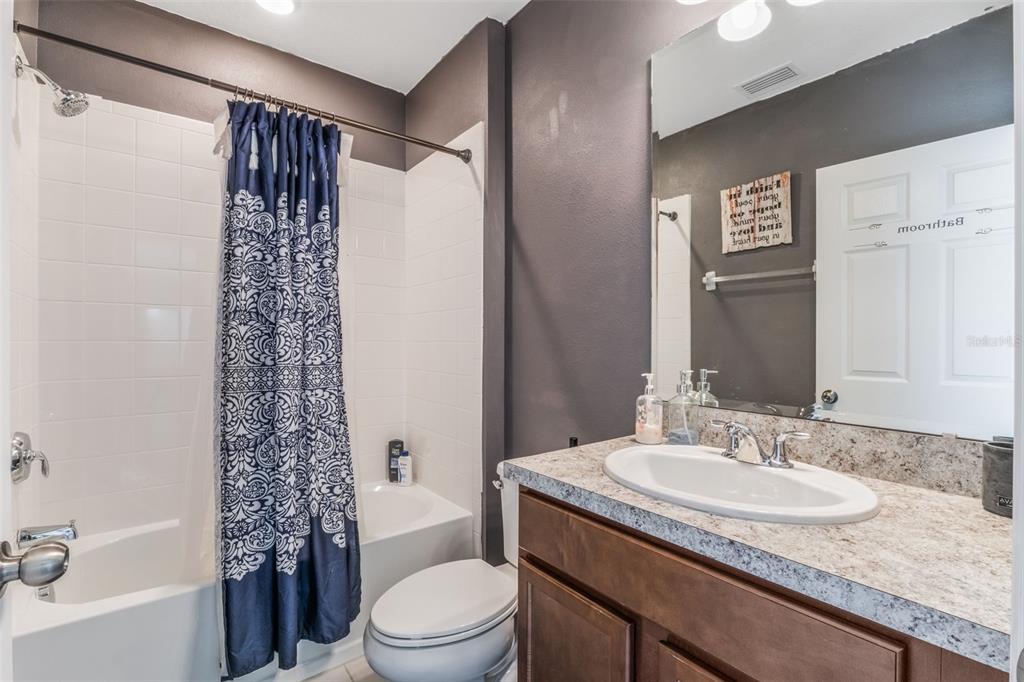 1108 Cavender Creek Road Minneola, FL 34715 - Photo 36 of 54 a bathroom with a granite countertop sink toilet and shower