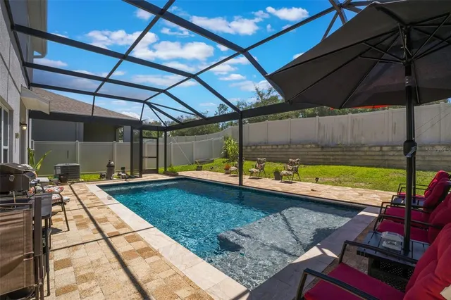 a view of a backyard with a patio and a yard