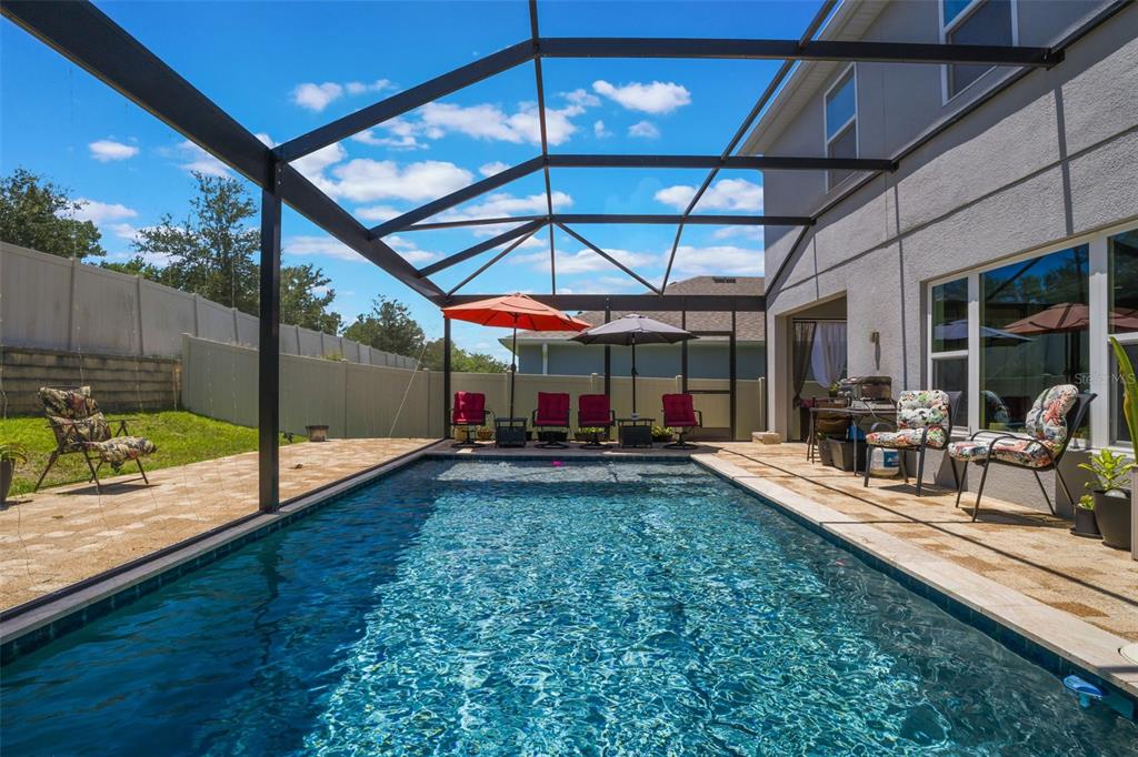 1108 Cavender Creek Road Minneola, FL 34715 - Photo 44 of 54 a view of a backyard with a patio and a yard