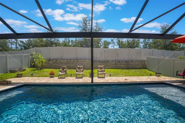 an aerial view of a house with garden space and street view