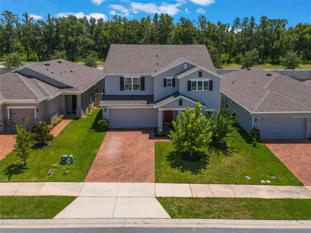 an aerial view of residential houses with outdoor space