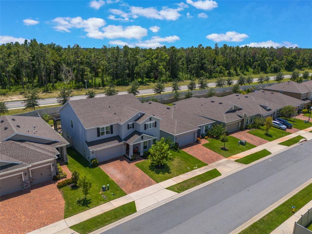 1108 Cavender Creek Road Minneola, FL 34715 - Photo 50 of 54 an aerial view of a house with garden space and street view