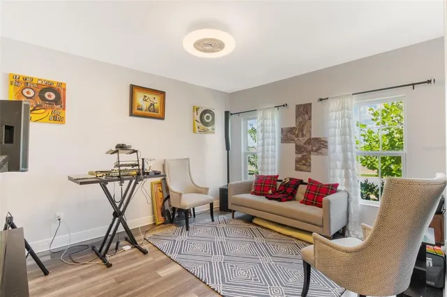 a living room with furniture and wooden floor